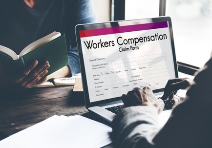 Man Filling Out a Workers' Compensation Claim Form
