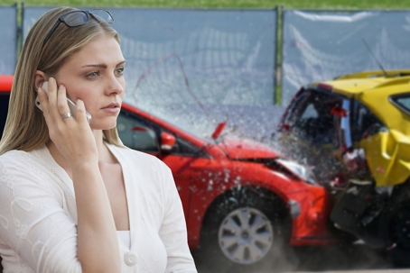 woman on phone outside near car crash
