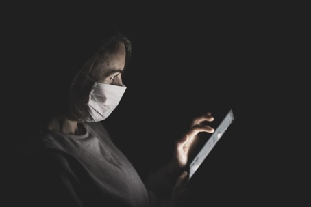 Woman with mask and tablet