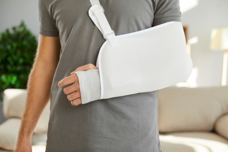 A person with a broken arm in a sling.