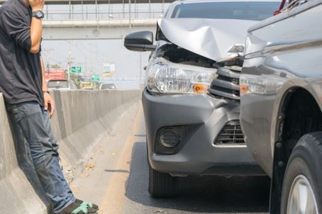 drunk driver on side of freeway next to car crash