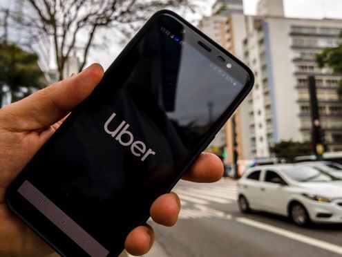 person using the uber app to call a ride