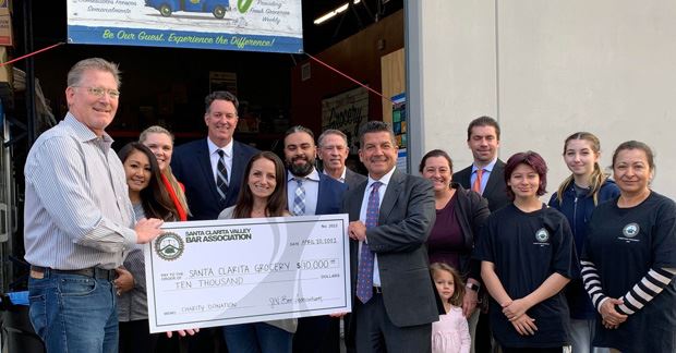 SCV Bar Association President handing a $10,000 check to Santa Clarita Grocery's Director